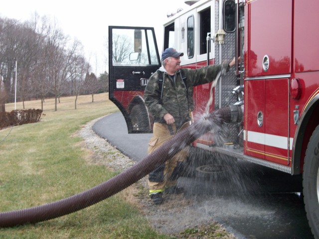 Firefighter Rick Woolson attempting to pull a draft a Cecil County fire.